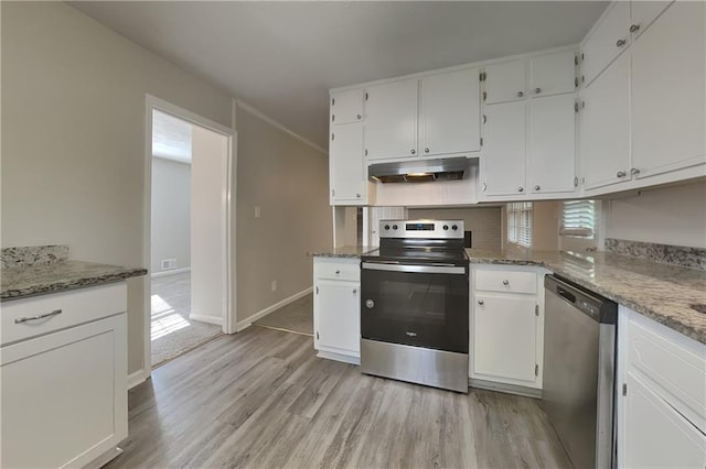 kitchen featuring stone counters, white cabinets, stainless steel appliances, and light wood-type flooring