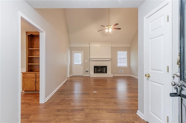260 Pleasant Grove Cir, Mcdonough, GA 30252 - unfurnished living room with lofted ceiling, ceiling fan, wood finished floors, a brick fireplace, and baseboards