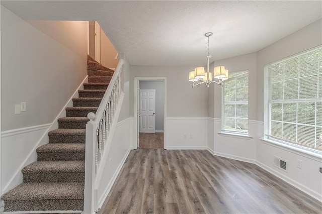 260 Pleasant Grove Cir, Mcdonough, GA 30252 - staircase with a chandelier, wood finished floors, and plenty of natural light