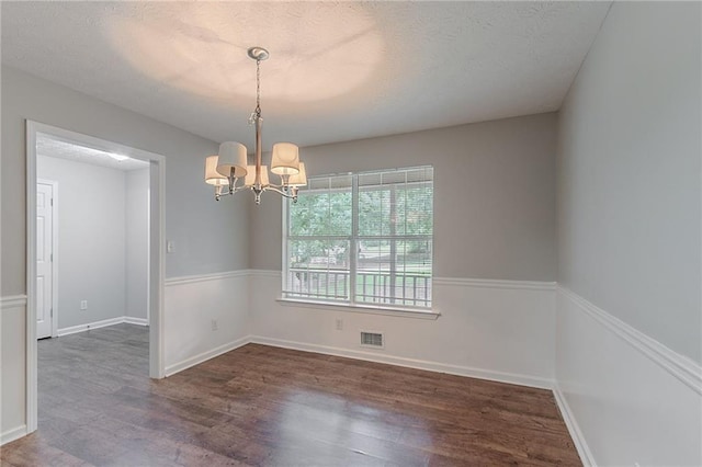 260 Pleasant Grove Cir, Mcdonough, GA 30252 - unfurnished room featuring a chandelier, wood finished floors, baseboards, and a textured ceiling