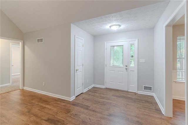 260 Pleasant Grove Cir, Mcdonough, GA 30252 - foyer entrance featuring wood finished floors, baseboards, and lofted ceiling