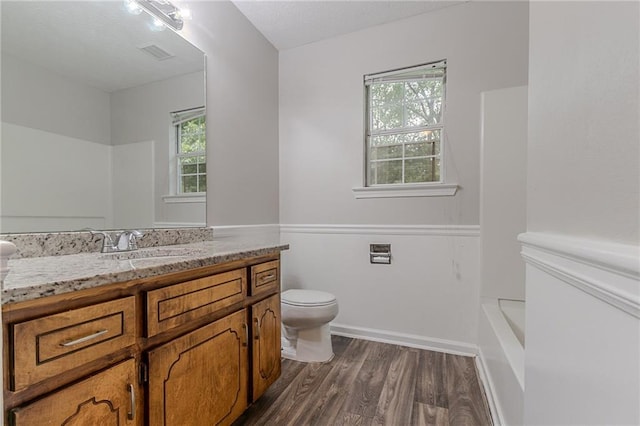 260 Pleasant Grove Cir, Mcdonough, GA 30252 - full bathroom featuring vanity, toilet, wood finished floors, and plenty of natural light