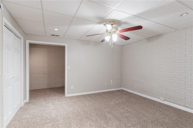 260 Pleasant Grove Cir, Mcdonough, GA 30252 - unfurnished bedroom with brick wall, carpet floors, a drop ceiling, baseboards, and a closet