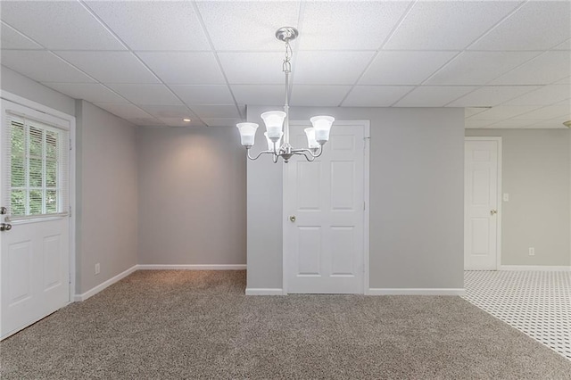 260 Pleasant Grove Cir, Mcdonough, GA 30252 - carpeted empty room with a paneled ceiling, a chandelier, and baseboards