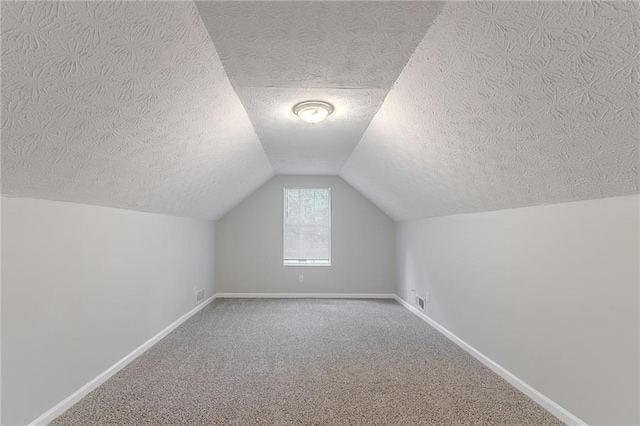 260 Pleasant Grove Cir, Mcdonough, GA 30252 - bonus room with a textured ceiling, carpet flooring, lofted ceiling, and baseboards