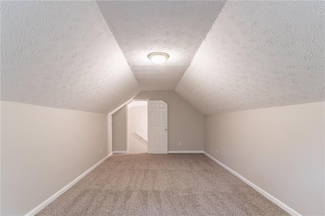 260 Pleasant Grove Cir, Mcdonough, GA 30252 - additional living space with a textured ceiling, baseboards, carpet flooring, and vaulted ceiling