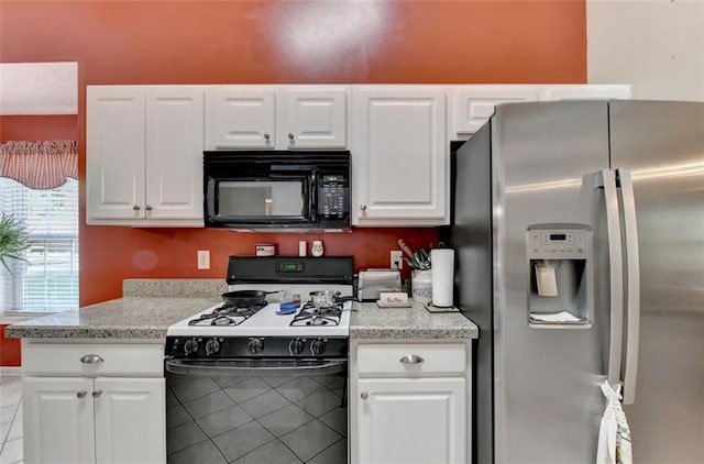 kitchen featuring light stone countertops, white cabinetry, light tile patterned floors, and black appliances