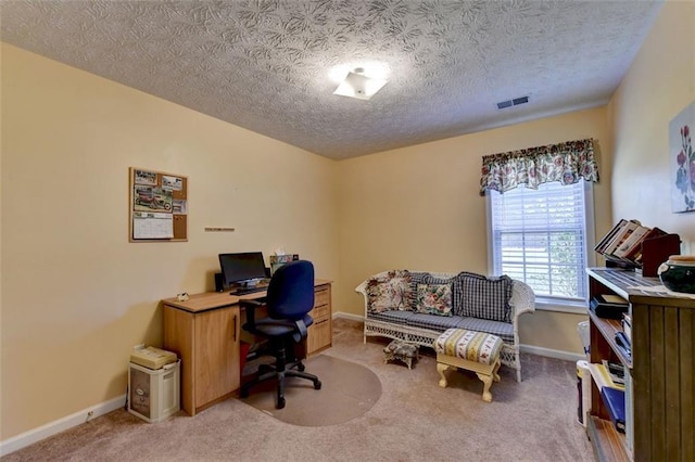 carpeted office with a textured ceiling