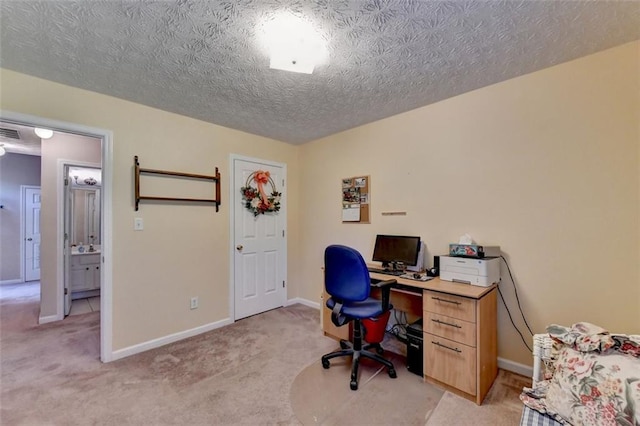 office featuring a textured ceiling and light colored carpet