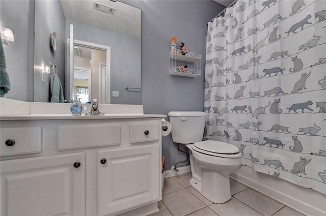 full bathroom featuring tile patterned flooring, vanity, toilet, and shower / bathtub combination with curtain