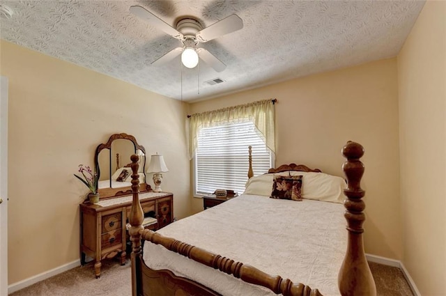 carpeted bedroom with a textured ceiling and ceiling fan