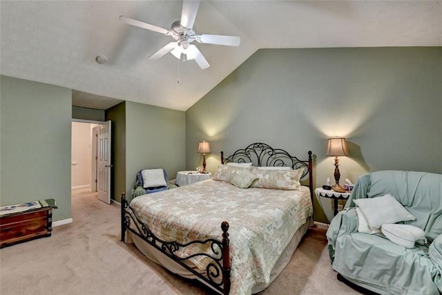 bedroom with light colored carpet, vaulted ceiling, and ceiling fan