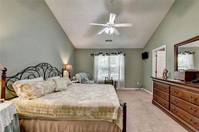 bedroom featuring multiple windows, ceiling fan, light colored carpet, and lofted ceiling