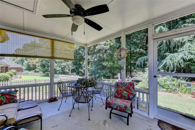 sunroom with ceiling fan and a healthy amount of sunlight