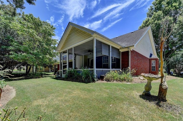 view of property exterior with a lawn and ceiling fan