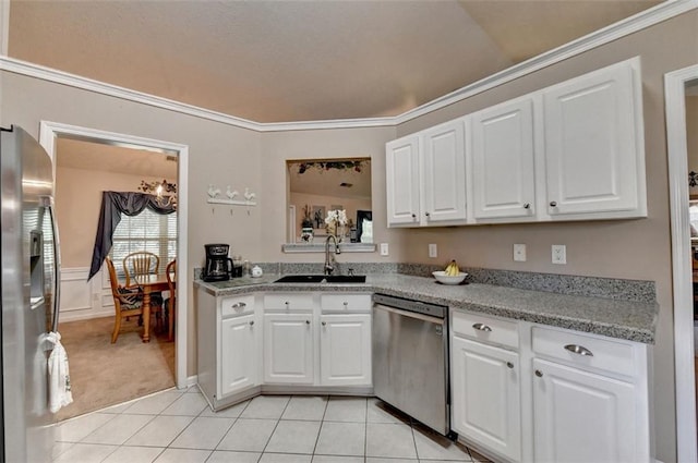 kitchen featuring white cabinets, appliances with stainless steel finishes, light tile patterned floors, and sink