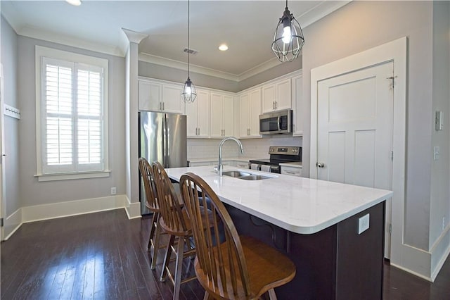 kitchen featuring baseboards, white cabinetry, a sink, appliances with stainless steel finishes, and backsplash