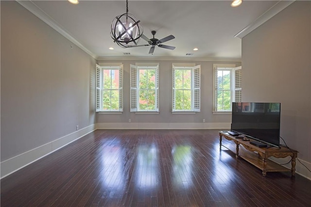 living room featuring crown molding, baseboards, plenty of natural light, and ceiling fan with notable chandelier