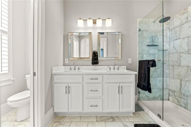 full bathroom featuring toilet, a shower stall, a sink, and marble finish floor