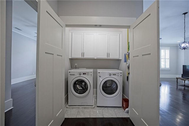 washroom with washer and dryer, cabinet space, baseboards, wood finished floors, and ornamental molding