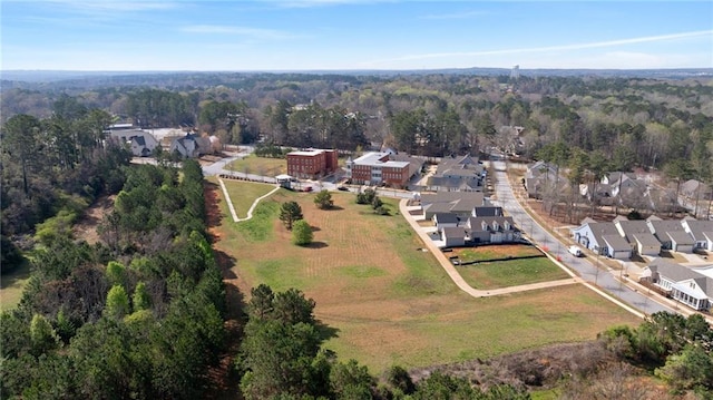 birds eye view of property featuring a residential view and a forest view