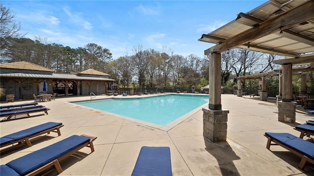 pool with a patio and fence