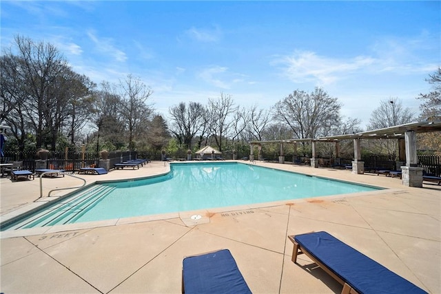 community pool featuring a patio and fence