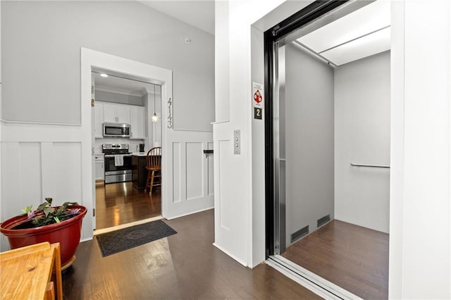hall featuring dark wood finished floors and elevator
