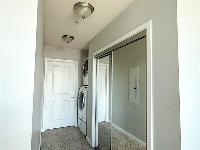 860 Peachtree St NE Unit 1411, Atlanta, GA 30308 - washroom featuring stacked washer and clothes dryer, carpet, electric panel, and baseboards