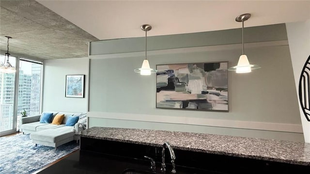 860 Peachtree St NE Unit 1411, Atlanta, GA 30308 - kitchen with a wall of windows, dark stone countertops, and pendant lighting