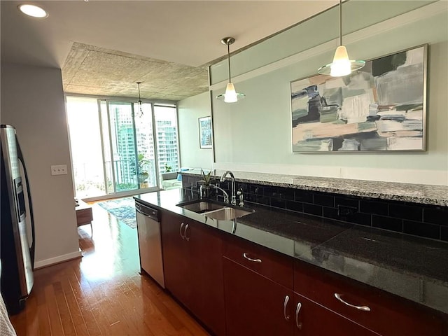 860 Peachtree St NE Unit 1411, Atlanta, GA 30308 - kitchen featuring stainless steel appliances, a wall of windows, a sink, dark wood finished floors, and pendant lighting