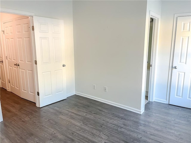 unfurnished bedroom featuring dark hardwood / wood-style floors