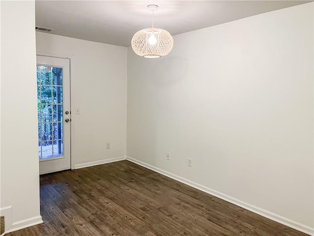 unfurnished room with dark wood-type flooring