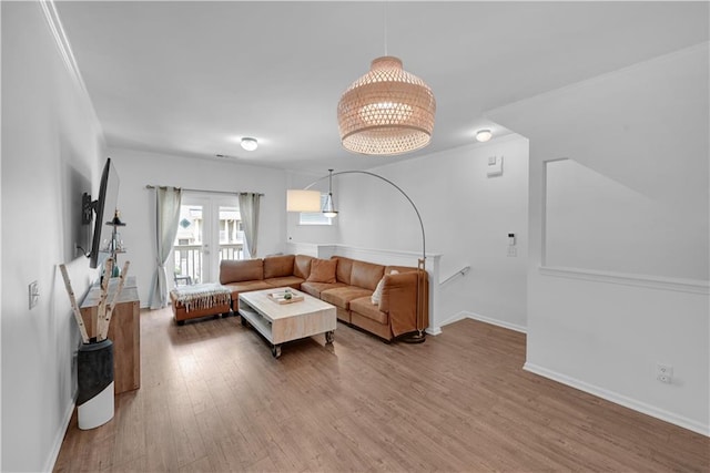 living room featuring ornamental molding and hardwood / wood-style flooring