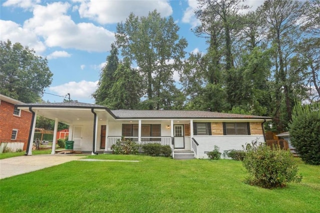 ranch-style house featuring a front lawn, an attached carport, covered porch, and concrete driveway