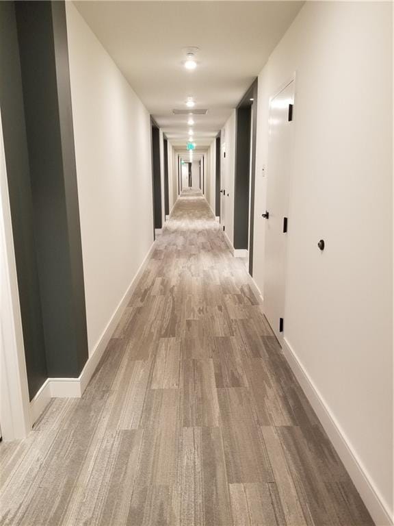 corridor featuring light hardwood / wood-style floors