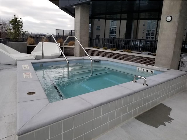 view of pool with a community hot tub