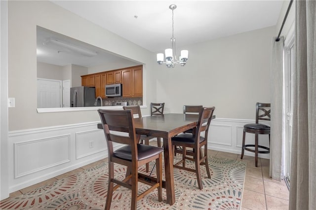 1804 Evadale Ct Unit 1, Mableton, GA 30126 - dining room featuring a decorative wall, a chandelier, light tile patterned flooring, and wainscoting