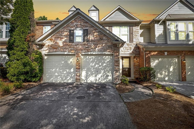 1804 Evadale Ct Unit 1, Mableton, GA 30126 - view of front facade featuring driveway, stone siding, and an attached garage