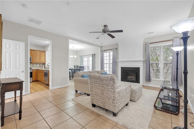 1804 Evadale Ct Unit 1, Mableton, GA 30126 - living room with light tile patterned flooring, healthy amount of natural light, a fireplace, and a ceiling fan