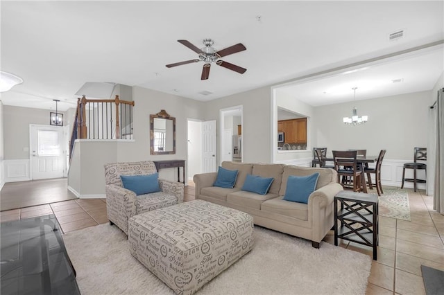1804 Evadale Ct Unit 1, Mableton, GA 30126 - living area with light tile patterned floors, a chandelier, a ceiling fan, wainscoting, and a decorative wall