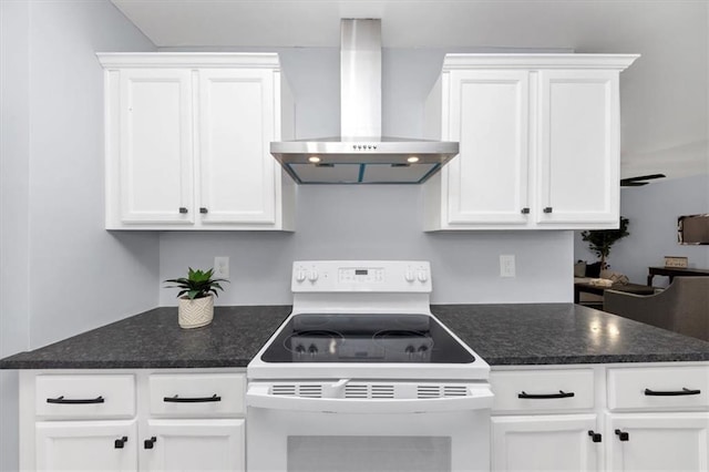 kitchen featuring wall chimney exhaust hood, white range with electric cooktop, and white cabinets