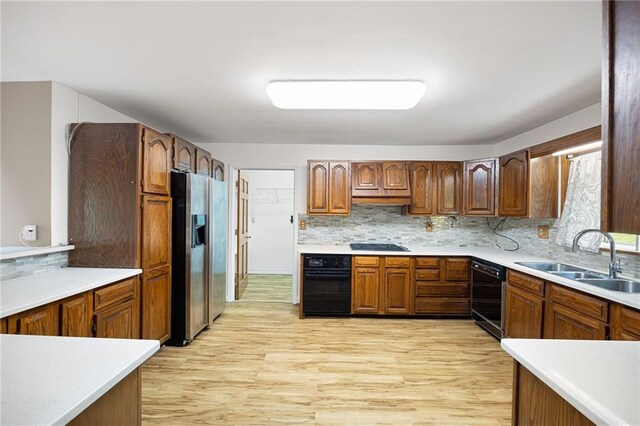 3272 Pinestream Rd NW, Atlanta, GA 30327 - kitchen featuring black appliances, light wood-style floors, backsplash, and light countertops