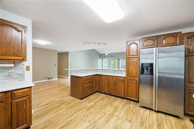 3272 Pinestream Rd NW, Atlanta, GA 30327 - kitchen featuring stainless steel refrigerator with ice dispenser, a peninsula, light wood-style flooring, light countertops, and backsplash