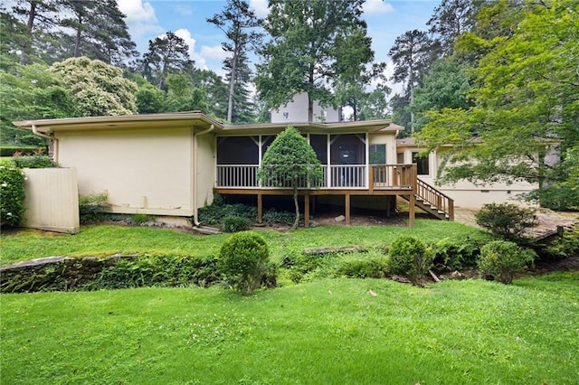 3272 Pinestream Rd NW, Atlanta, GA 30327 - back of property with a sunroom, a lawn, stairway, and stucco siding