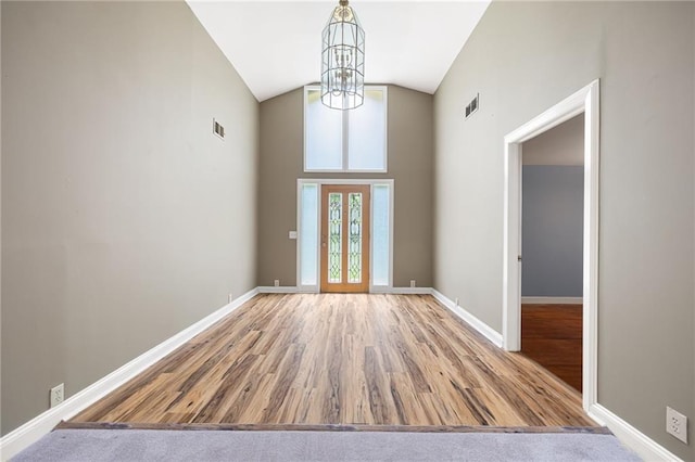 3272 Pinestream Rd NW, Atlanta, GA 30327 - unfurnished dining area featuring wood finished floors, a chandelier, and high vaulted ceiling