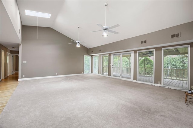 3272 Pinestream Rd NW, Atlanta, GA 30327 - unfurnished living room featuring high vaulted ceiling, a skylight, ceiling fan, and light carpet