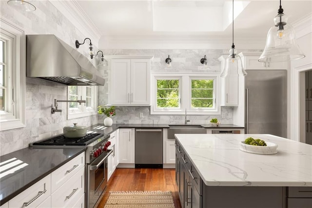 2015 N Decatur Rd NE, Atlanta, GA 30307 - kitchen featuring range hood, tasteful backsplash, dark wood-style flooring, a sink, and stainless steel appliances