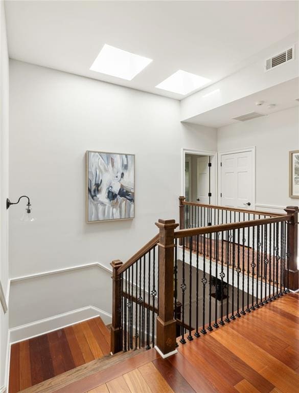 2015 N Decatur Rd NE, Atlanta, GA 30307 - stairs featuring baseboards, a skylight, wood-type flooring, and visible vents