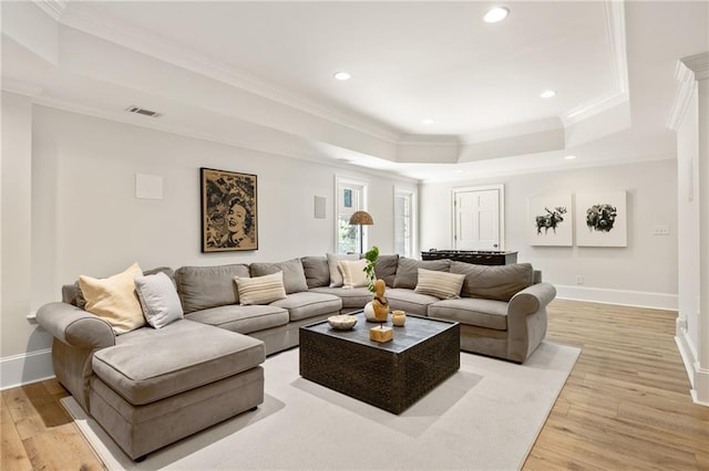 2015 N Decatur Rd NE, Atlanta, GA 30307 - living room featuring a tray ceiling, light wood-style floors, and baseboards